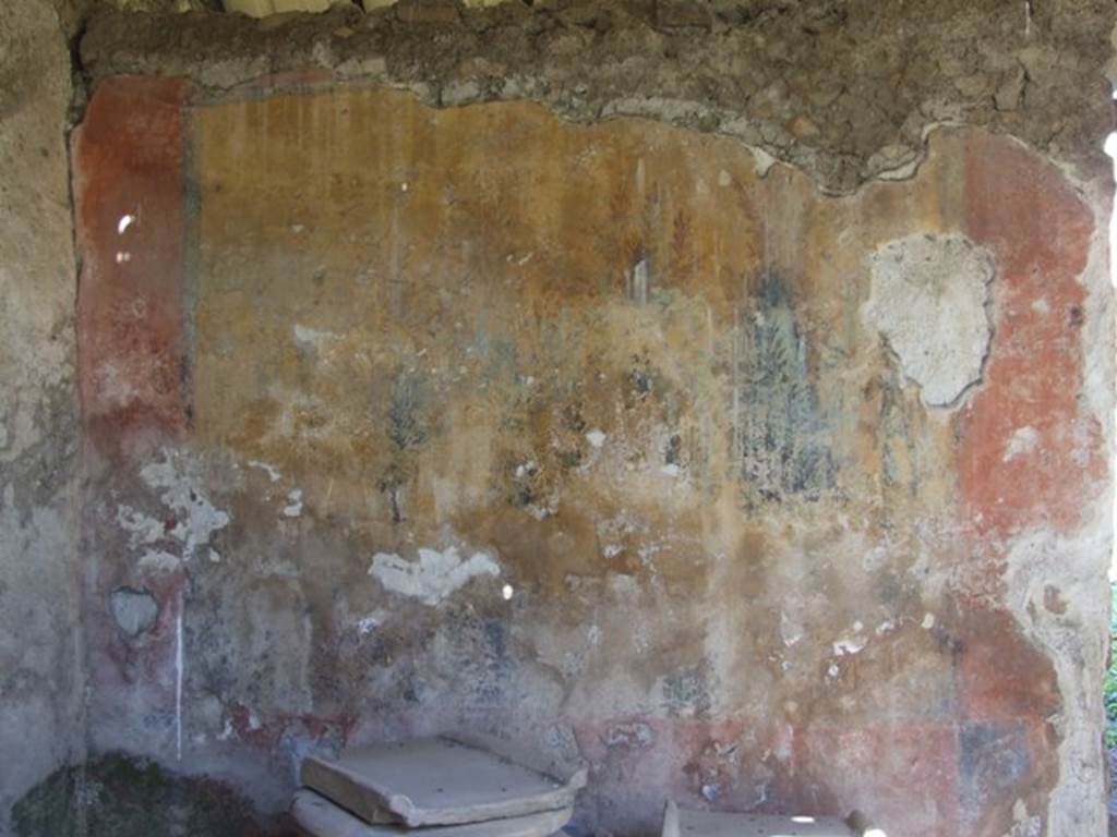 I.12.8 Pompeii. March 2009. Room 9, west side of north wall with remains of garden painting. According to Curtis, the major panels of the painting depicted a garden scene with thick foliage. The left panel was much deteriorated, but both panels contained paintings of life-like birds standing on branches of green trees and shrubbery. According to Jashemski, she could see four song-birds in a thicket of ivy, flowering oleanders and myrtles.
The bottom part of the painting was destroyed. See Jashemski, W. F., 1993. The Gardens of Pompeii, Volume II: Appendices. New York: Caratzas, (p.326 and fig.378)