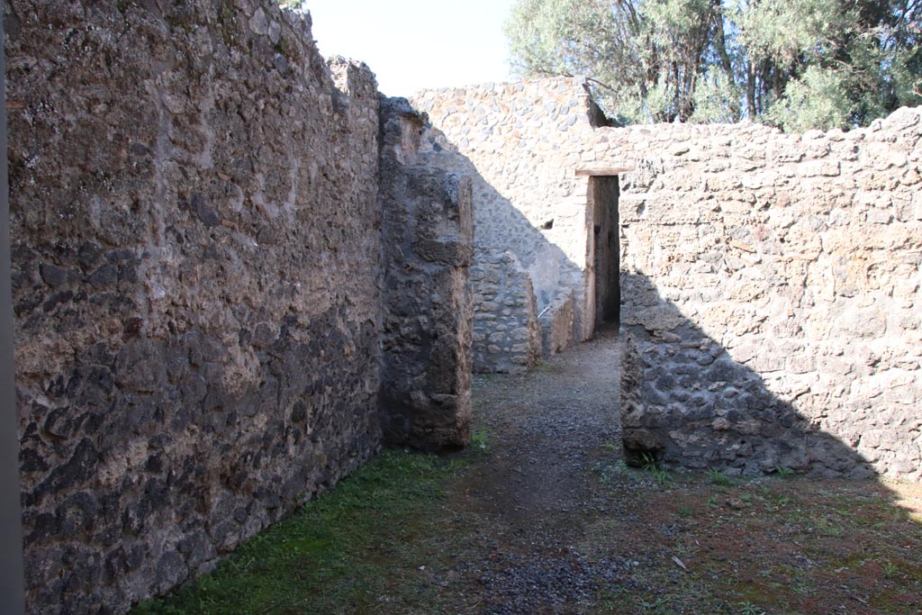 I.12.8 Pompeii. March 2009. Doorway to room 6 and north west corner.