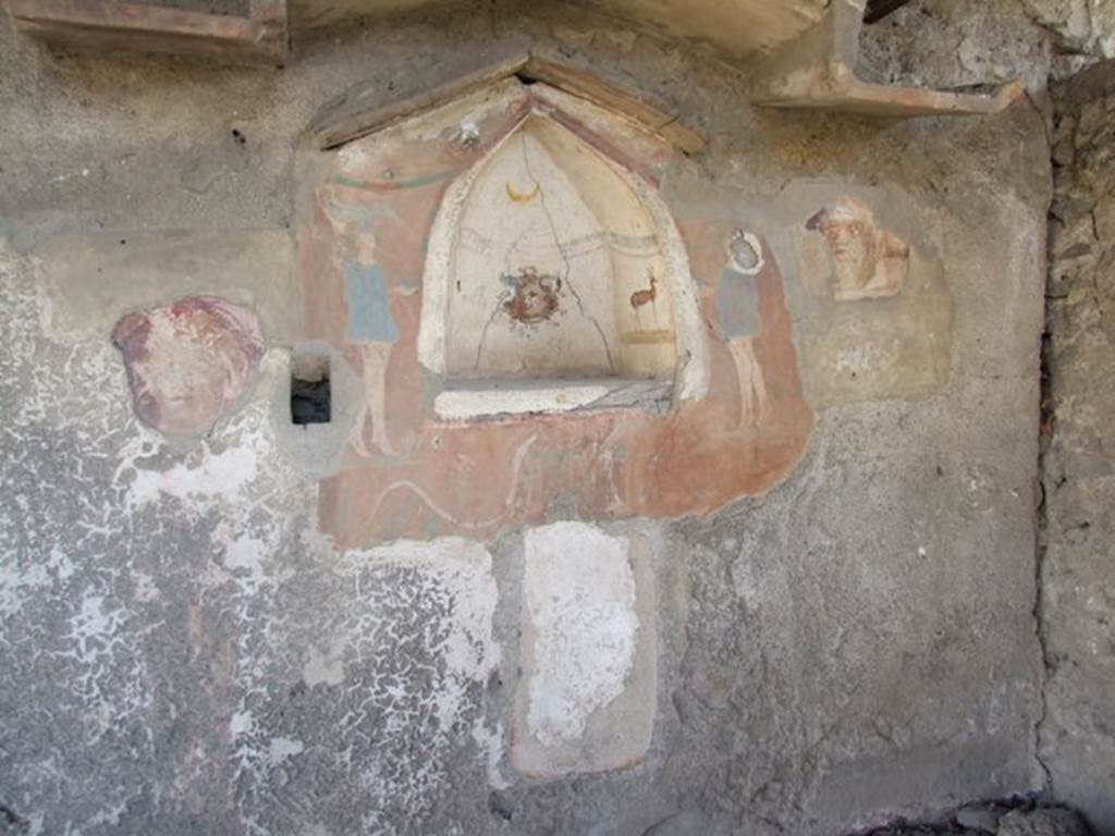 I.12.15 Pompeii. March 2009. Room 5. East wall. Lararium, with niche, and the remains of faces on either side. See Fröhlich, T., 1991. Lararien und Fassadenbilder in den Vesuvstädten. Mainz: von Zabern. (L27, T:4,1).
