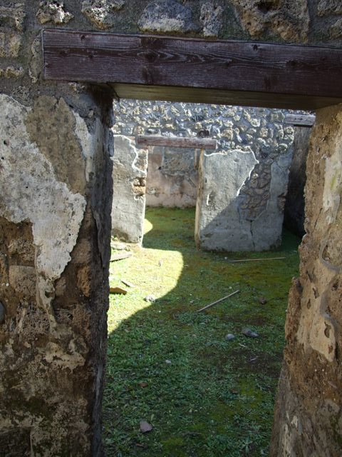 I.13.15 Pompeii. March 2009.  Room on north-east side of central courtyard, looking at north-east corner and north wall.
