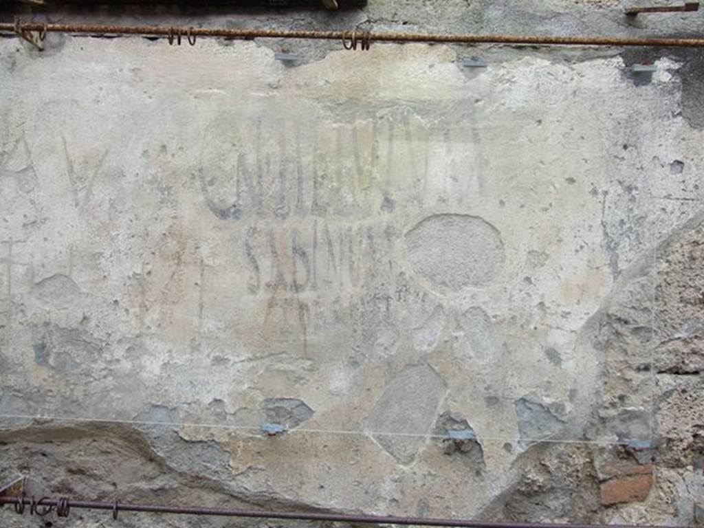 I.14.7/8 Pompeii. December 2006. Graffiti between I.14.7 and I.14.8. 
According to Varone and Stefani, this is CIL IV 9919.
See Varone, A. and Stefani, G., 2009. Titulorum Pictorum Pompeianorum, Rome: L�erma di Bretschneider, (p.164 & 166)
 
According to Epigraphik-Datenbank Clauss/Slaby (See www.manfredclauss.de), this reads as �

Cn(aeum)  Helvium 
Sabinum  aed(ilum)  d(ignum)  r(ei)  p(ublicae) 
Porcellus  cum  suis  rog(at)       [CIL IV 9919]

According to Cooley, CIL IV 9919 translates as �
Porcellus with his household asks for Cn. Helvius Sabinus as aedile, worthy of public office.  
See Cooley, A. and M.G.L., 2004. Pompeii : A Sourcebook. London : Routledge, p. 122, F50.
