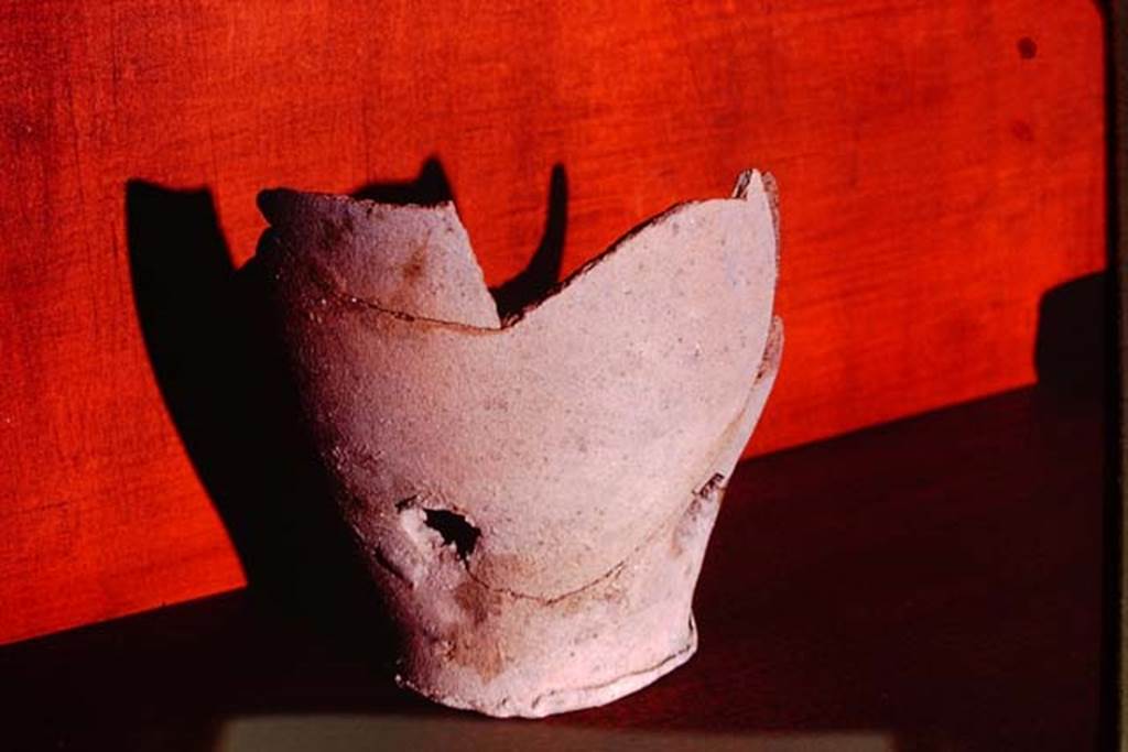 I.15.3 Pompeii. 1972. Terracotta pot from the soil. Photo by Stanley A. Jashemski. 
Source: The Wilhelmina and Stanley A. Jashemski archive in the University of Maryland Library, Special Collections (See collection page) and made available under the Creative Commons Attribution-Non Commercial License v.4. See Licence and use details. J72f0819
According to Wilhelmina, 
��.Among the important discoveries in this garden were the 28 terracotta pots found embedded in the soil at varying depths, at intervals along the 4 walls.  With the exception of six half-pots, these were similar to the two that had been previously found.  8 of the pots were only slightly below the surface of the ground.  14 were found at the bottom of root cavities ranging in depth from 7 to 42 cm.  A cluster of 6 appeared to be half pots. The pots, with one exception, have one hole in the bottom and 3 on the sides.   All of these pots (13 of which were sufficiently complete to be restored) are of a coarse clay and vary in colour from red to black�.
See Jashemski, W. F., 1993. The Gardens of Pompeii, Volume II: Appendices. New York: Caratzas. (p.62)
