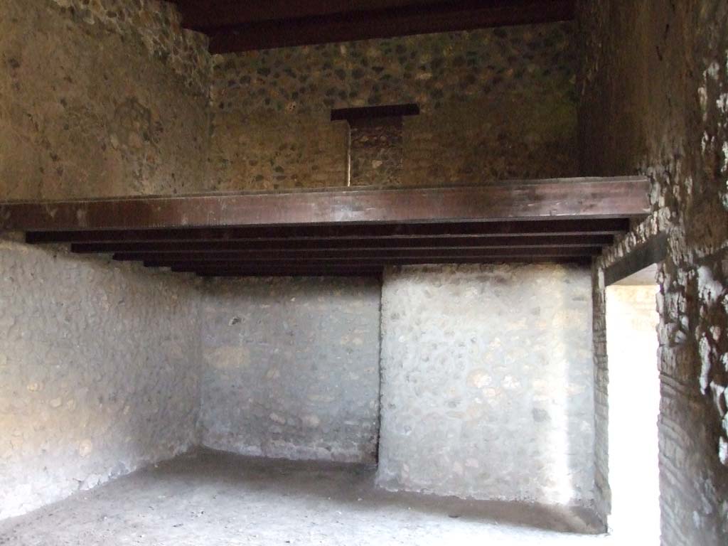 I.15.3 Pompeii. December 2007. Room 11 in south-west corner of peristyle, next to kitchen.
The stairs in the kitchen, room 9, would have led to the door on the upper floor. Looking north.