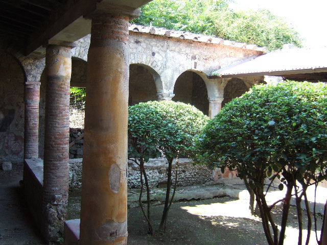 I.17.4 Pompeii. May 2006. Open area or yard on south side of peristyle garden. Reconstructed wooden upper gallery.