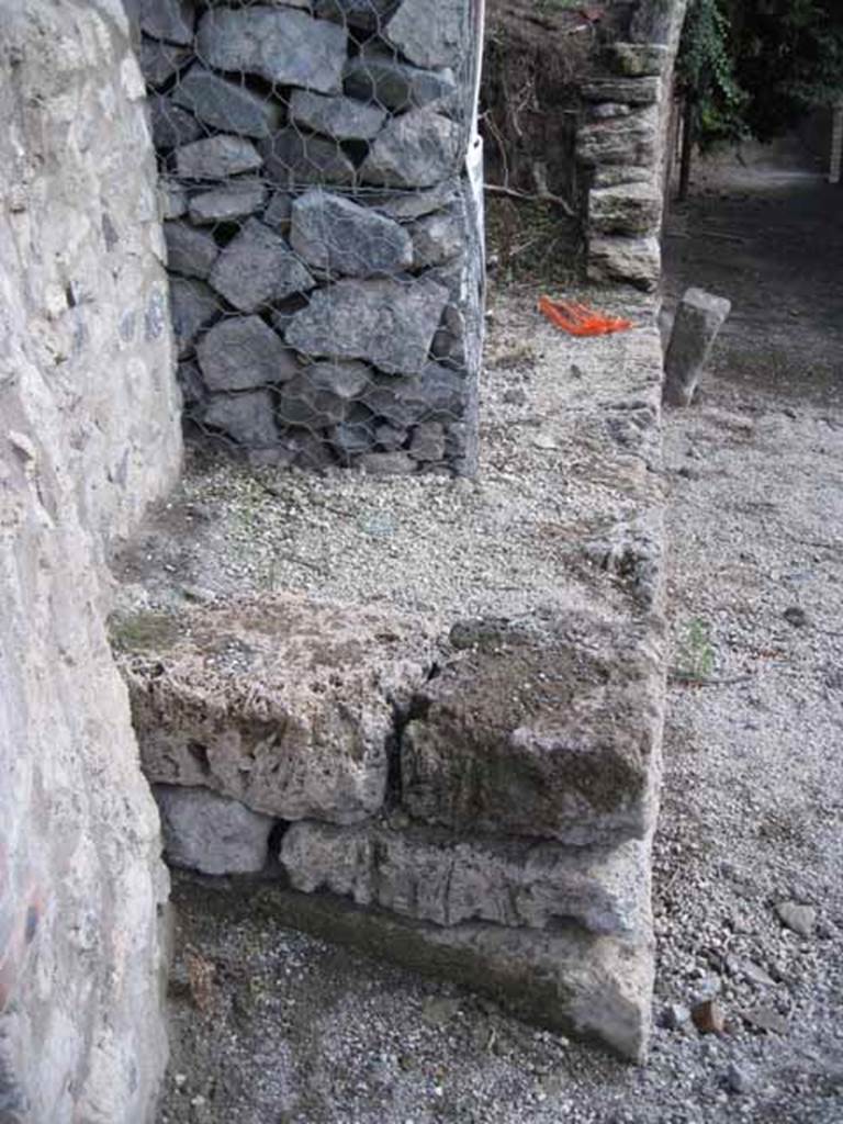 I.2.22 Pompeii. September 2010. Looking south to restored south end of insula I.19, into the unexcavated, on the east side of Vicolo del Citarista.
Photo courtesy of Drew Baker.