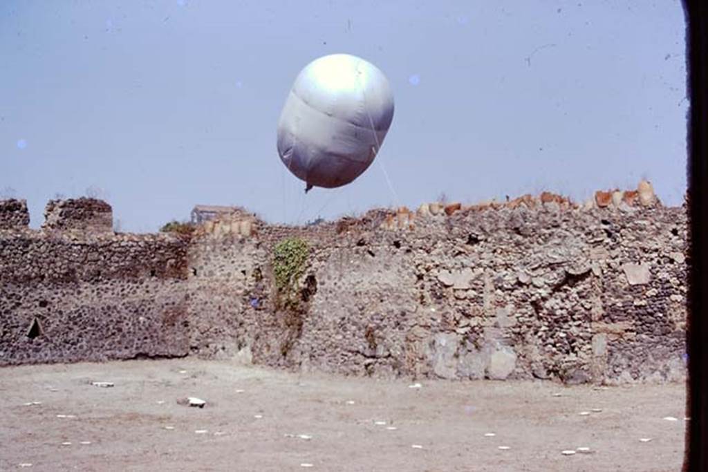 I.20.5 Pompeii. 1974. Looking towards north-west corner, and the �balloon� in Via della Palestra.  Photo by Stanley A. Jashemski.   
Source: The Wilhelmina and Stanley A. Jashemski archive in the University of Maryland Library, Special Collections (See collection page) and made available under the Creative Commons Attribution-Non Commercial License v.4. See Licence and use details. J74f0442
