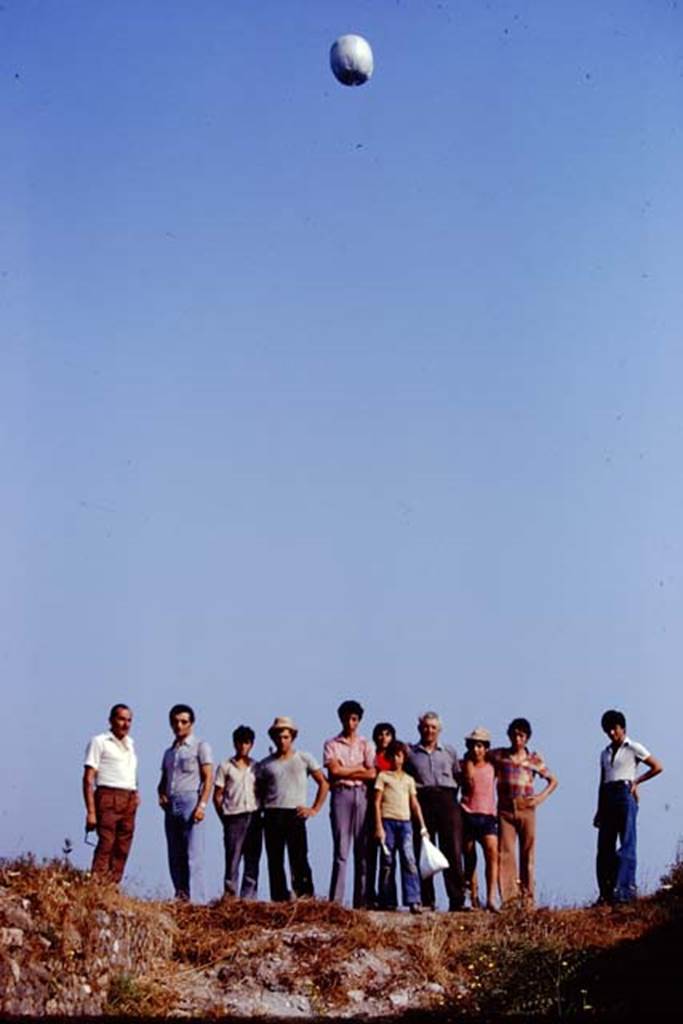 I.22 Pompeii. 1974. Sig. Sicignano and workers waiting for the arrival of the “balloon”. Photo by Stanley A. Jashemski.
Source: The Wilhelmina and Stanley A. Jashemski archive in the University of Maryland Library, Special Collections (See collection page) and made available under the Creative Commons Attribution-Non Commercial License v.4. See Licence and use details. J74f0415
