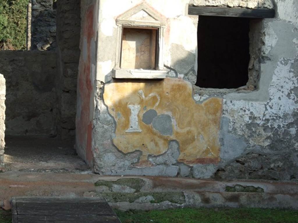 II.1.9 Pompeii. December 2007. Lararium.  Between the niche and the window was a painting of Hercules standing with his club, now faded or missing.   
See Fr�hlich, T., 1991, Lararien und Fassadenbilder in den Vesuvst�dten.  Mainz: von Zabern.  (L39, p.265, T. 29, 4).
See Rivista di Study Pompeiani, X, 1999, Un ensemble de pots � peinture � Pomp�i, by Barbet, Tuffreau-Libre, Coupry. (p.71-81). SAP photo of lararium upon excavation, and a drawing of it by Barbet, can be seen on pages 74 and 75.

