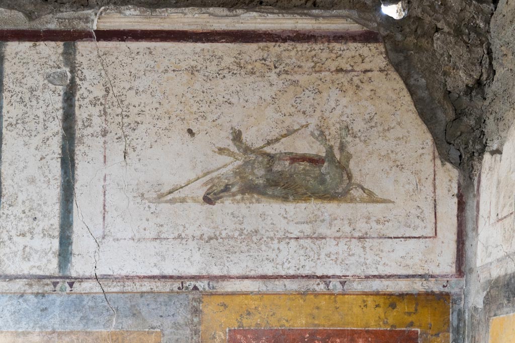 II.1.12 Pompeii. July 2021.
Triclinium, upper south wall at west end, with painted panel of a dead boar. Photo courtesy of Johannes Eber.