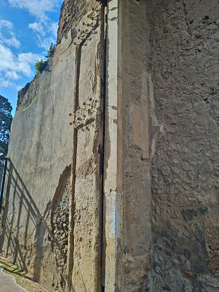 II.2.2 Pompeii. March 2024. 
West side of entrance doorway with plaster cast of doorway shutter. Photo courtesy of Giuseppe Ciaramella.
