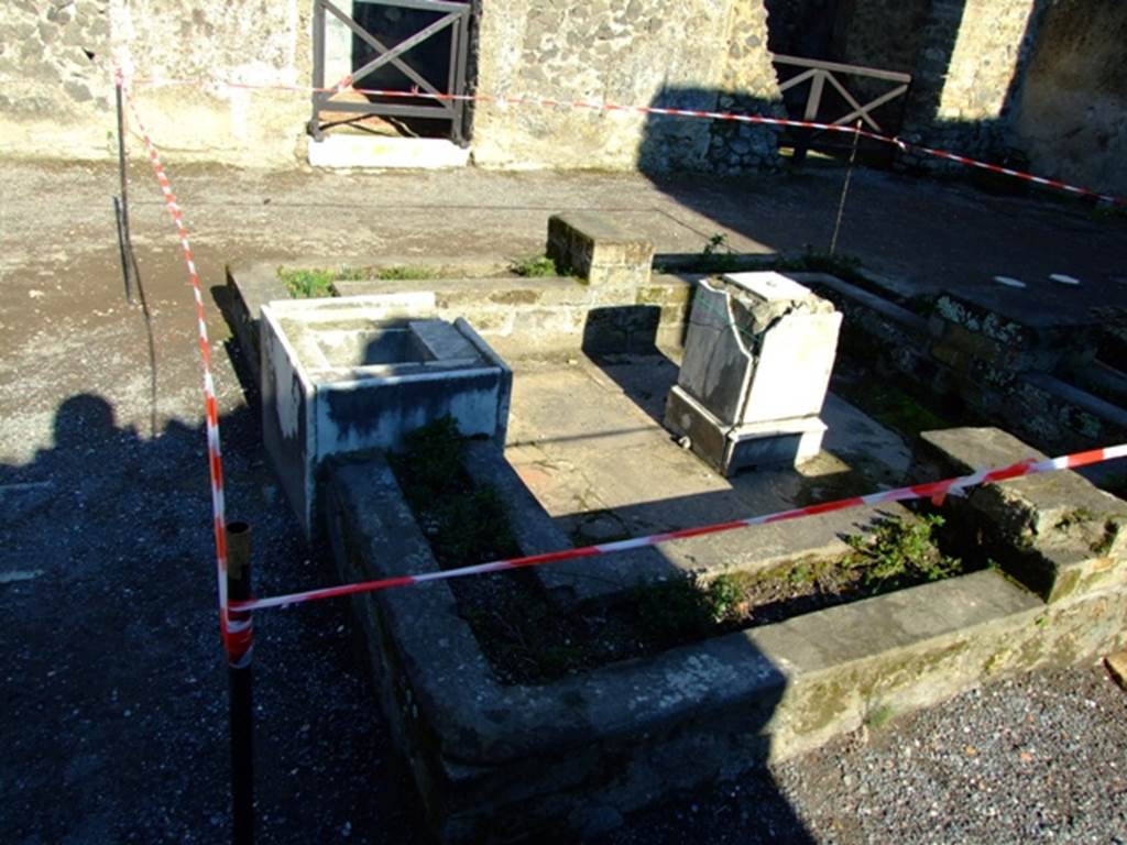 II.2.2 Pompeii. March 2009. Room 2, atrium. Looking east across impluvium and fountain.
The east and west sides of the impluvium were badly damaged by bombing in 1943 and have been rebuilt.
See Jashemski, W. F., 1993. The Gardens of Pompeii, Volume II: Appendices. New York: Caratzas. (p.78)