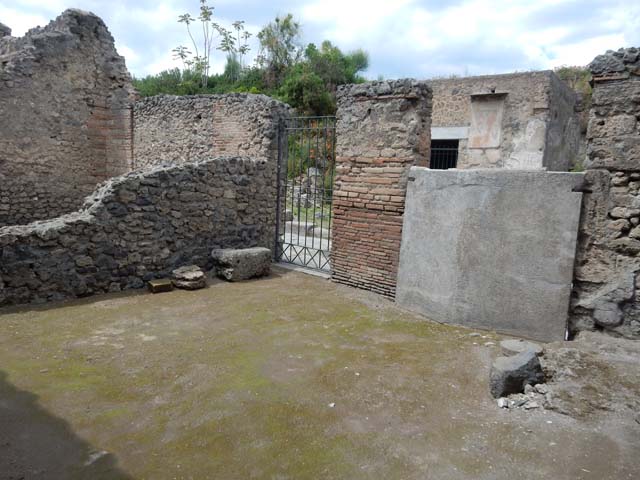II.3.2 Pompeii. December 2007.  Remains of painted plaster on east wall of workshop.