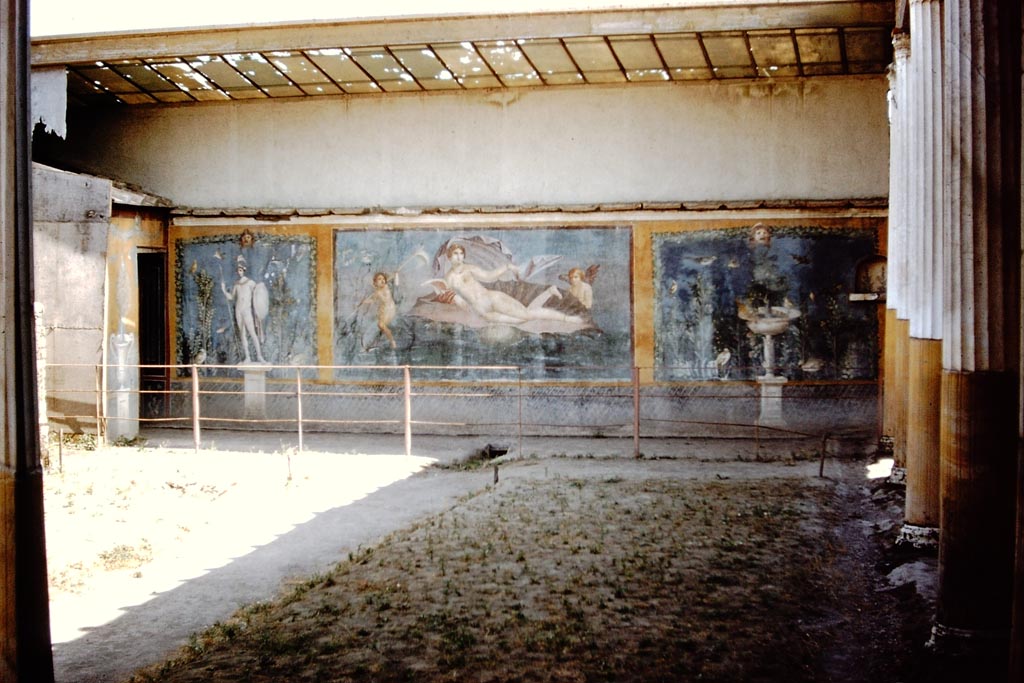 II.3.3 Pompeii. July 2007. Room 11, west panel of south wall of peristyle. 
Wall painting of fountain with garden, mask and birds. Photograph courtesy of Kathryn Breen.
