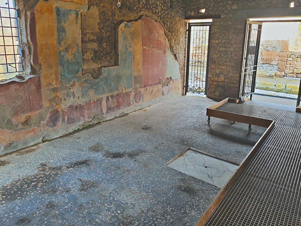 II.4.3 Pompeii. March 2024.
Looking towards north-west corner of atrium, and doorway at II.4.2, on left, and II.4.3, on right. Photo courtesy of Giuseppe Ciaramella.