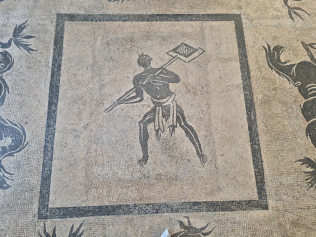 II.4.6 Pompeii. June 2024.
Black and white mosaic from centre of floor showing a furnaceman and a marine scene set in floor of Naples Museum.
Photo courtesy of Giuseppe Ciaramella.