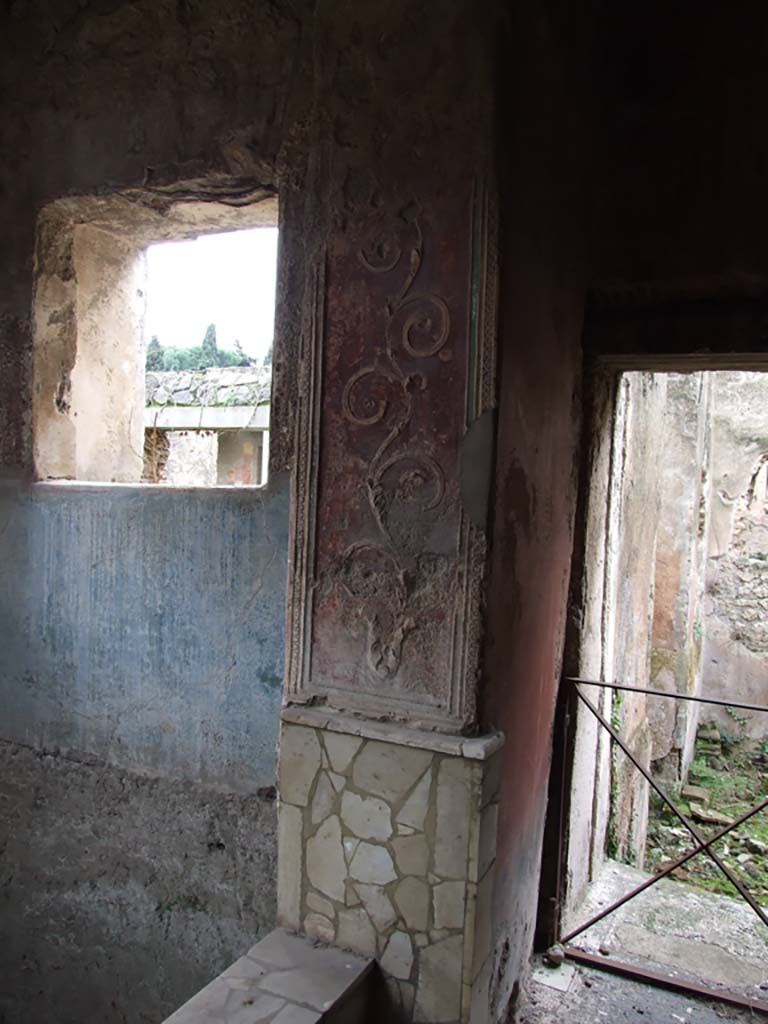 II.4.6 Pompeii. December 2006.
Frigidarium/apodyterium, detail of west side, and doorway to tepidarium or warm bath-room with remains of a black and white mosaic threshold.