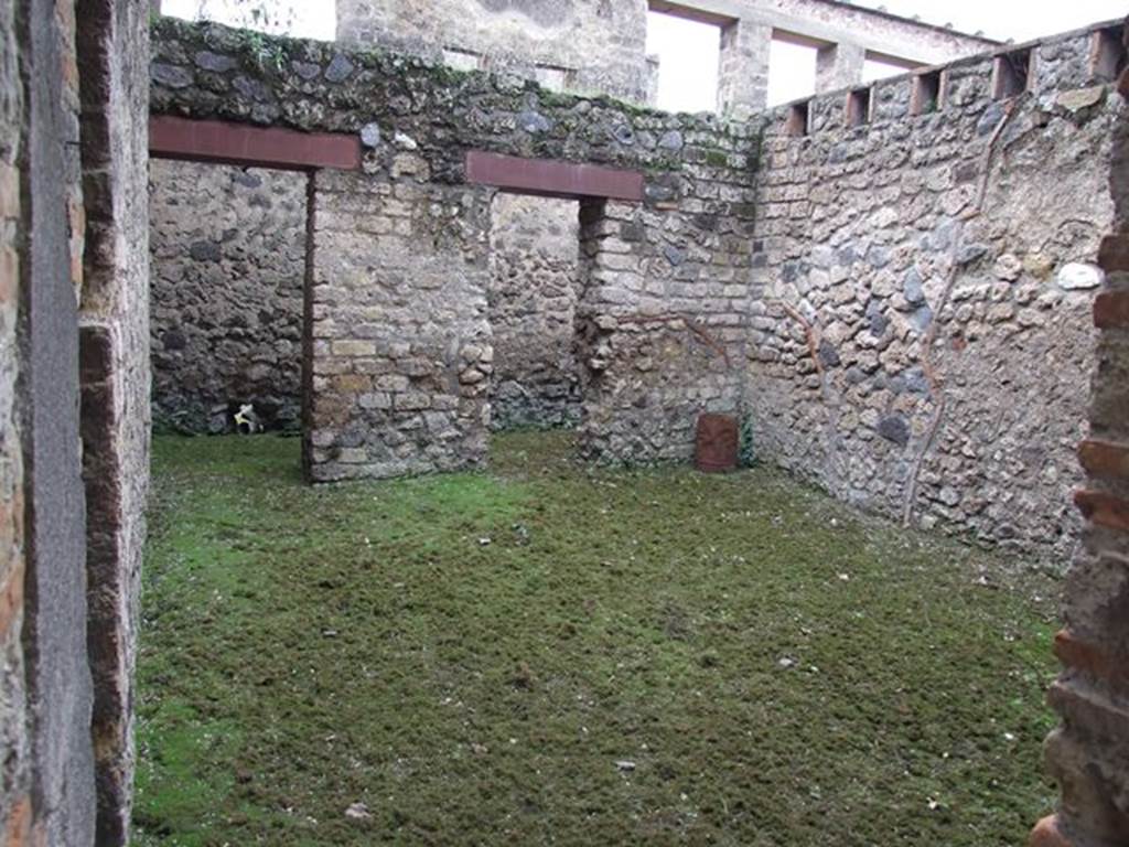 II.4.6 Pompeii. December 2006. Looking through doorway from west portico into room with two doorways in its west wall into a corridor, at the rear.