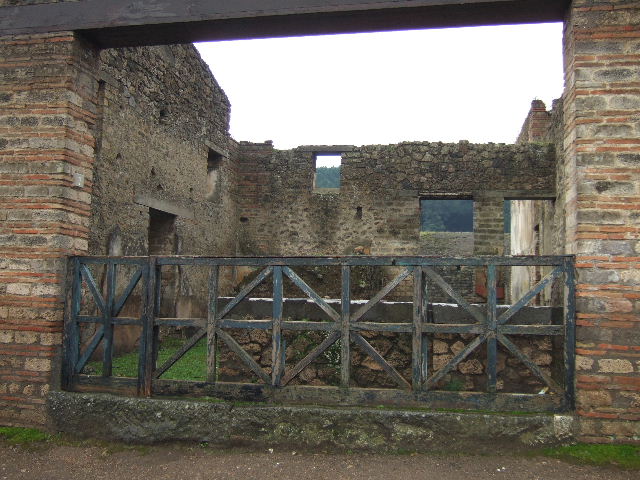 II.4.7 Pompeii. December 2005. Food counter and door in east wall to triclinium.
