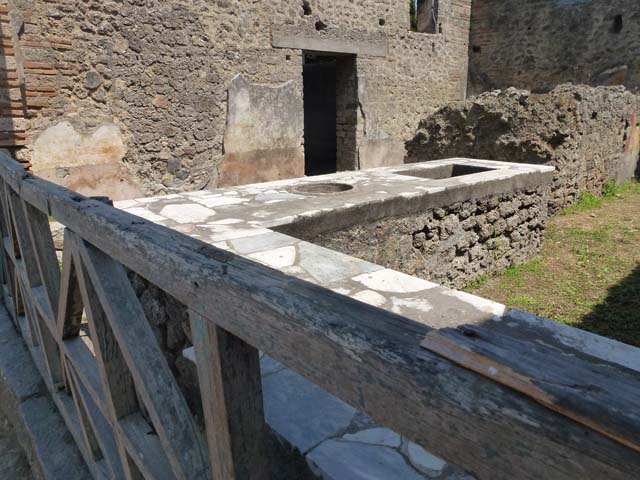 II.4.7 Pompeii. December 2006. Stone seats and tables in compartments.

