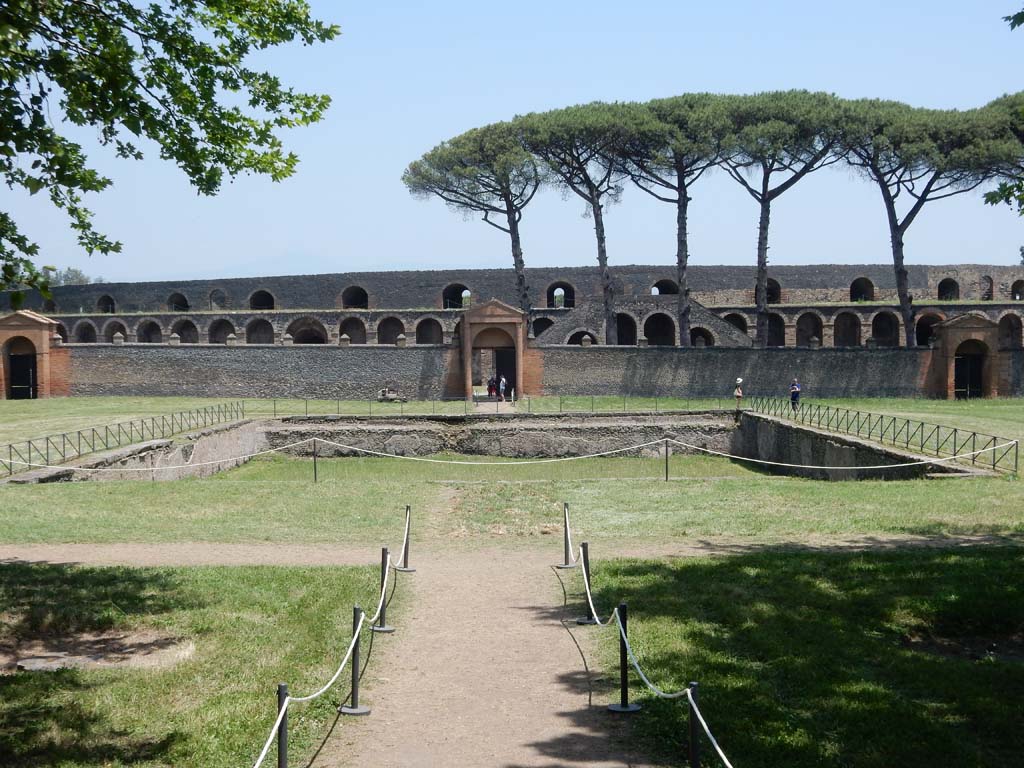 II.7.4 on left, 11.7.3 centre, II.7.2, on right. Pompeii. June 2019. Looking east across pool in palestra from doorway at II.9.
Photo courtesy of Buzz Ferebee.


