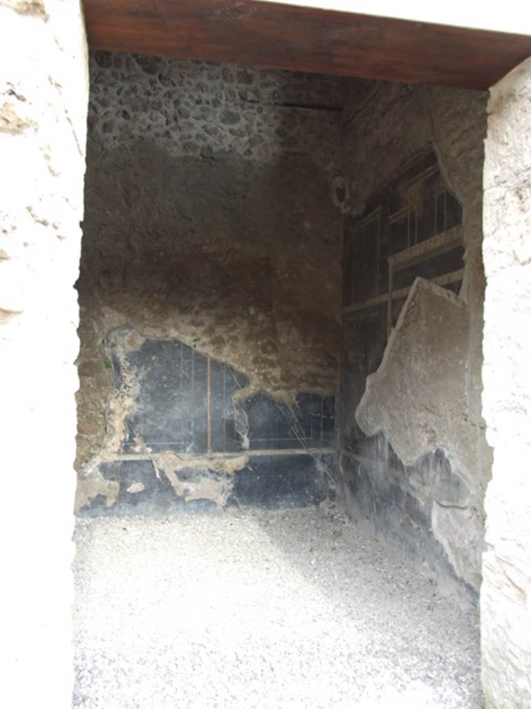 III.2.1 Pompeii. March 2009.
Doorway to room 7, from room 6, looking east along south wall towards south-east corner.
The south wall must have been affected by the 1943 bombing.