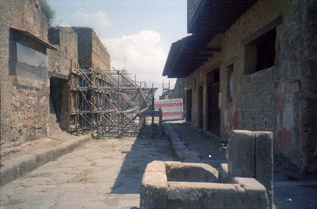 III.2.3 Pompeii. July 2011. Looking east on Via dell�Abbondanza, showing scaffolding outside entrance. Photo courtesy of Rick Bauer.