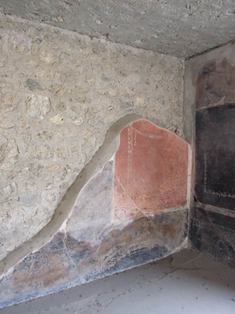 III.4.3 Pompeii. March 2009. Room 3. Triclinium. Remains of painted panel on west wall in north west corner. The area in the centre was partially demolished by the 1943 bombing and the central panel, with the third of the famous moral sayings, was lost.
Lascivos voltus et blandos aufer ocellos
Coniuge ab alterius : sit tibi in ore pudor.
See Della Corte, M., 1965. Case ed Abitanti di Pompei. Napoli: Fausto Fiorentino. (p.361. CIL IV 7698a-c)