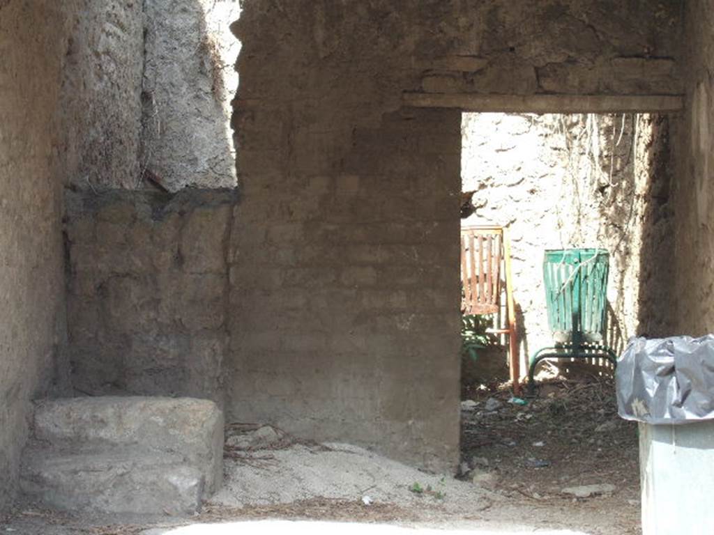 III.5.1 Pompeii. September 2005. Steps to upper floor with two steps remaining. To the right is the door to the rear room which has a window to the north, which is not excavated. According to Liselotte Eschebach, this may have been a grocery shop. The upstairs may have been rented out as a workshop. Tools and furniture fittings were found there. See Eschebach, L., 1993. Geb�udeverzeichnis und Stadtplan der antiken Stadt Pompeji. K�ln: B�hlau. (p. 107).