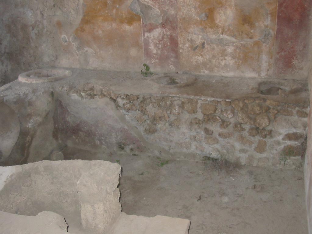 III.6.1 Pompeii. May 2003. Looking towards west wall, across hearth at end of counter. Photo courtesy of Nicolas Monteix.