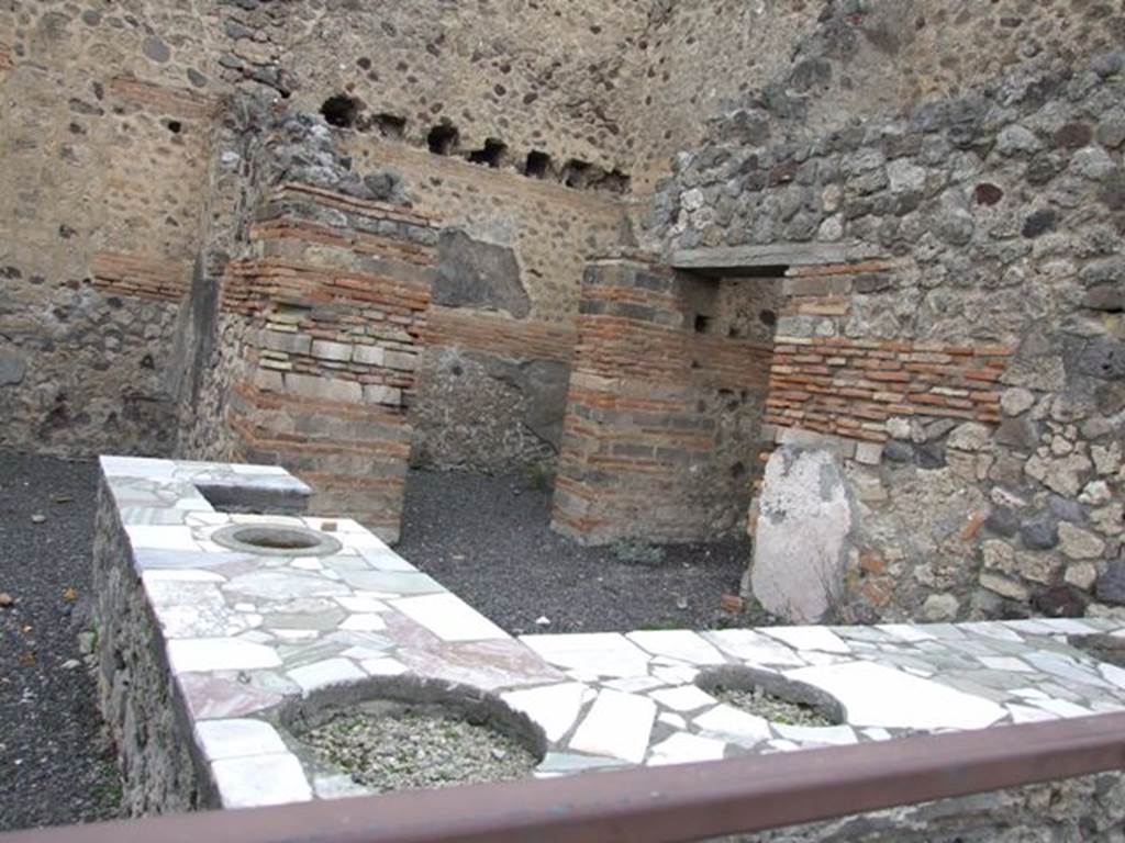 V.1.1 Pompeii. December 2007. Marble counter with four urns and hearth.