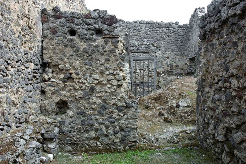 V.1.23 Pompeii.
Room “q”, east wall, with doorway into kitchen and towards rear doorway at V.1.10. Photo by Hans Thorwid.
Photo courtesy of the Swedish Pompeii Project.
(See V.1.10 for extract from BdI, 1876 referring to this area)