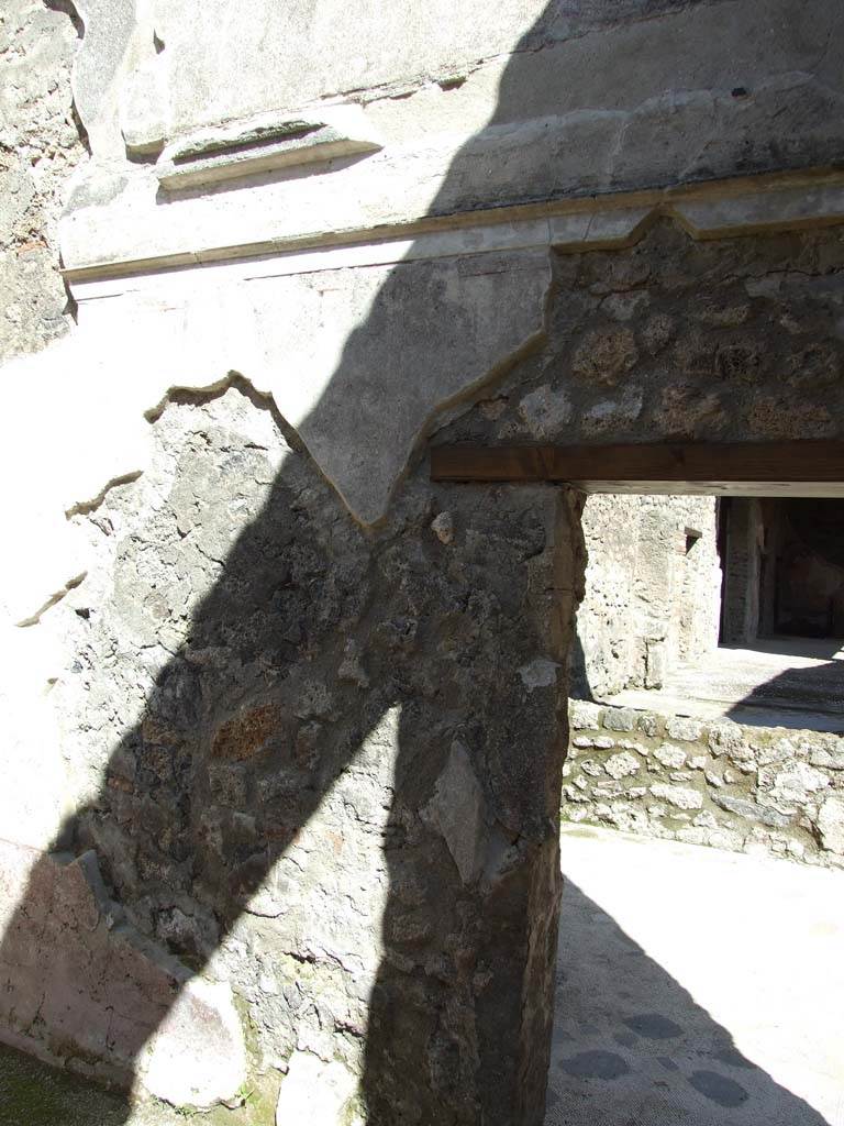 V.1.26 Pompeii. March 2009.
Room “d”, remains of plaster, cornice and decoration on east wall of second cubiculum.