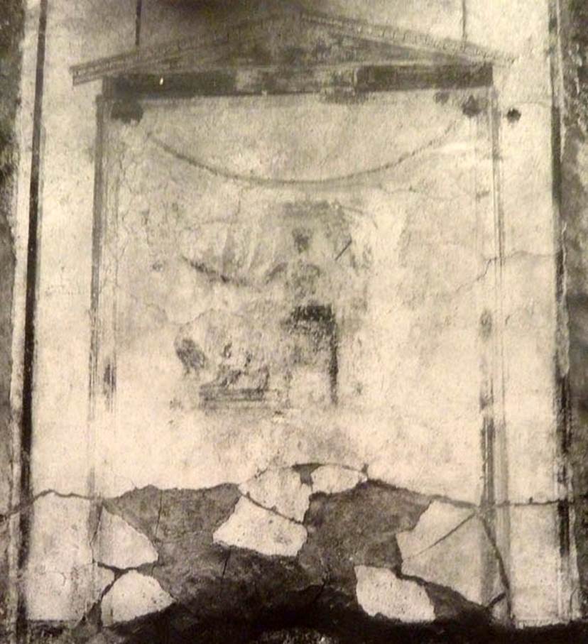 V.2.15 Pompeii. Old undated photograph. North wall of peristyle garden 11c. Remains of central painting in lararium.
Giove (Jupiter) sits on a throne, his lower body covered with a green robe. 
The sceptre is in the left hand, leaning on the arm of the throne. 
The lightning bolt is in his outstretched right hand and the eagle at his feet. 
See Notizie degli Scavi di Antichit�, 1894, p. 439.
