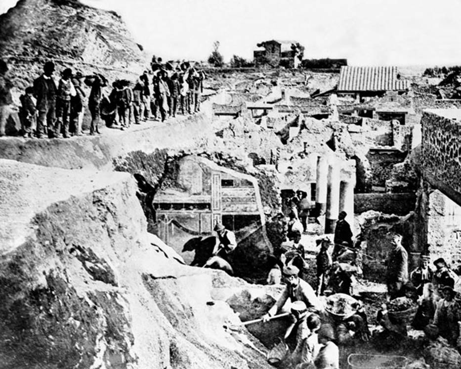 V.2.15 Pompeii. Late 19th century photograph showing excavation, (c.1896).
Looking south from south-east corner of V.2.i, across the columns of the peristyle garden of Casa di Orione/V.2.15, towards the rear of the Casina dell�Aquila in the distance. 
In the centre front, the second style decoration on south wall of Corinthian oecus, room 21 of The House of the Silver Wedding at V.2.i can be seen.
Photo courtesy of Rick Bauer.
