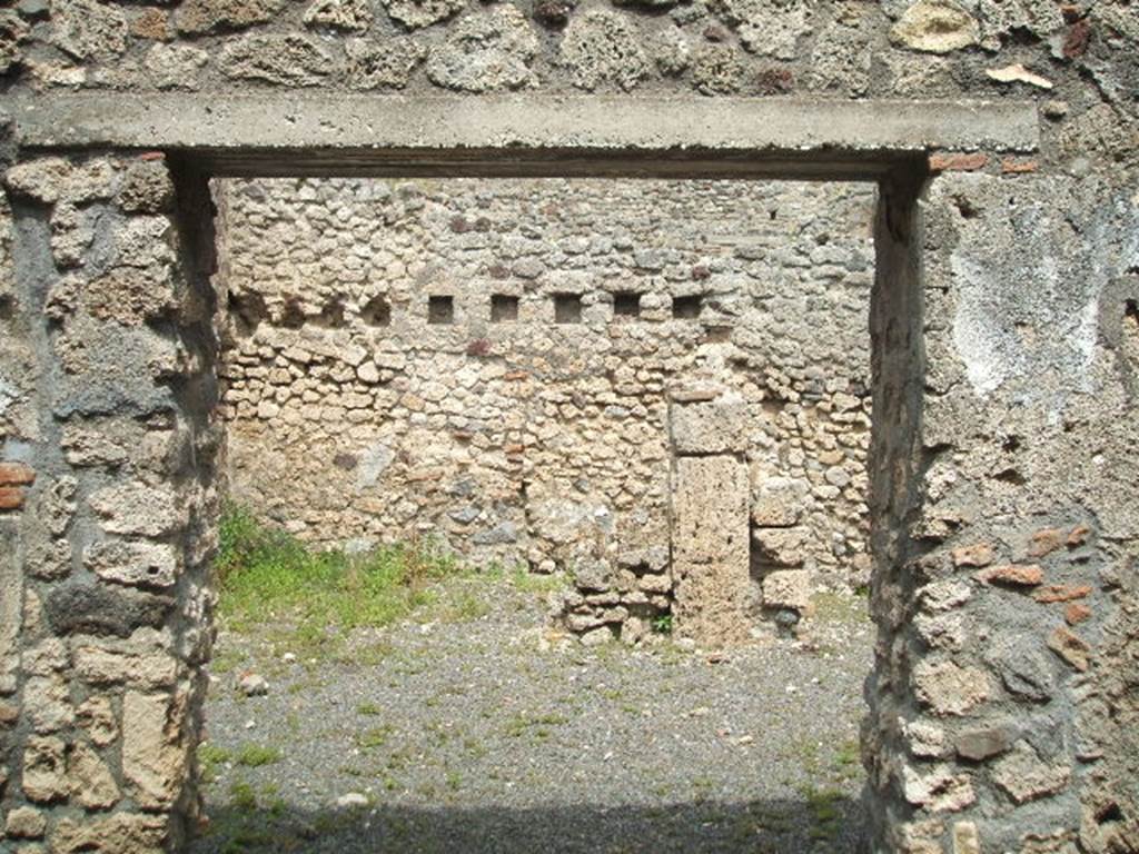 V.2.f  Pompeii. May 2005. Entrance, looking east. According to NdS, the atrium was devoid of an impluvium, but to the right of where one entered was a small hearth. Above the hearth was a semicircular niche and a short distance away, in the south-west corner of the atrium, was a latrine which would have been protected by a lean-to roof. See Notizie degli Scavi, 1896, (p.436. See Mau in BdI, VIII, 1893, (p.7-9)
According to Boyce, just to the right of the entrance against the west wall in the atrium stood a low masonry altar. Traces of fire were seen on the top of the altar when it was first excavated. Above the altar was an arched niche in the wall.
When Boyce wrote (1937) he said �the last layer of plain white stucco has fallen from the interior walls, revealing a finer layer beneath it� This was white and decorated with red spots. Not photographed yet, it may not be still there. See Boyce G. K., 1937. Corpus of the Lararia of Pompeii. Rome: MAAR 14. (p.36, 103)
According to Giacobello, the hearth was located near the niche in the south corner of the atrium. On the same west wall, to the left of the Lararium is a second smaller niche, and also a trace of a third niche to the left again. See Giacobello, F., 2008. Larari Pompeiani: Iconografia e culto dei Lari in ambito domestico.  Milano: LED Edizioni. (p.164 with photo).
