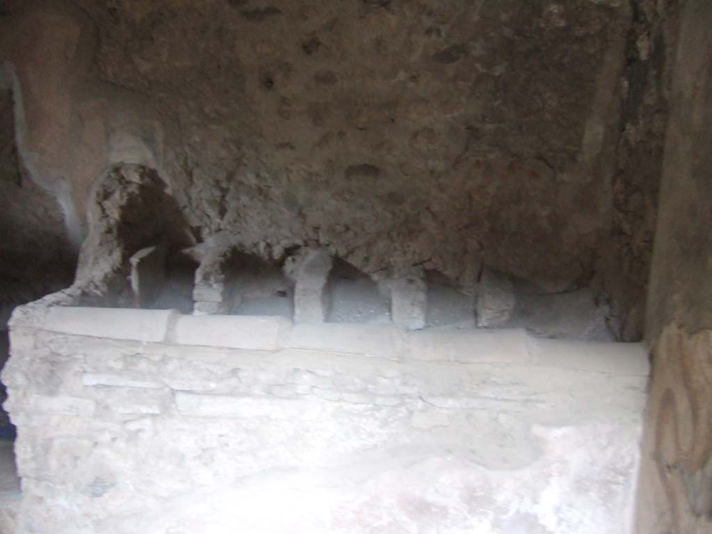 V.2.h Pompeii. December 2005. Kitchen ‘p’ in north-east corner of atrium, with hearth ‘2’, looking east.
According to Boyce, the lararium was on the south wall.
On the right of the picture can be seen the remains of the lararium serpents.
See Boyce G. K., 1937. Corpus of the Lararia of Pompeii. Rome: MAAR 14. (p.37, no.107, Pl.17,2)
To the left of the hearth was a latrine ‘1’.