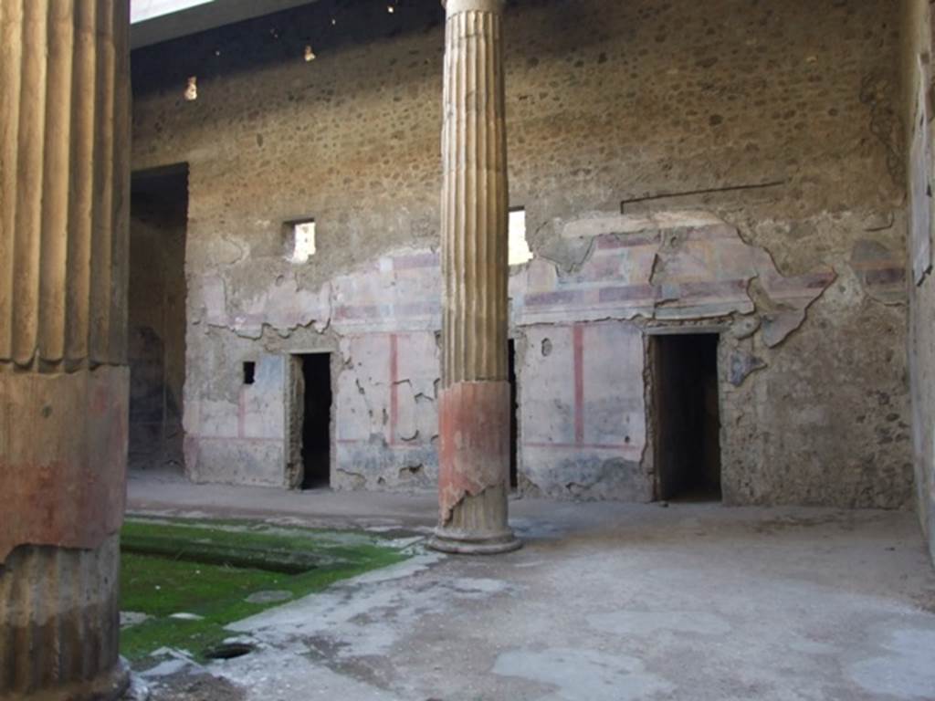 V.2.i Pompeii. December 2007.
Looking south-west towards west side of atrium and windows of rooms in upper floor. On the left is room 8, west ala.