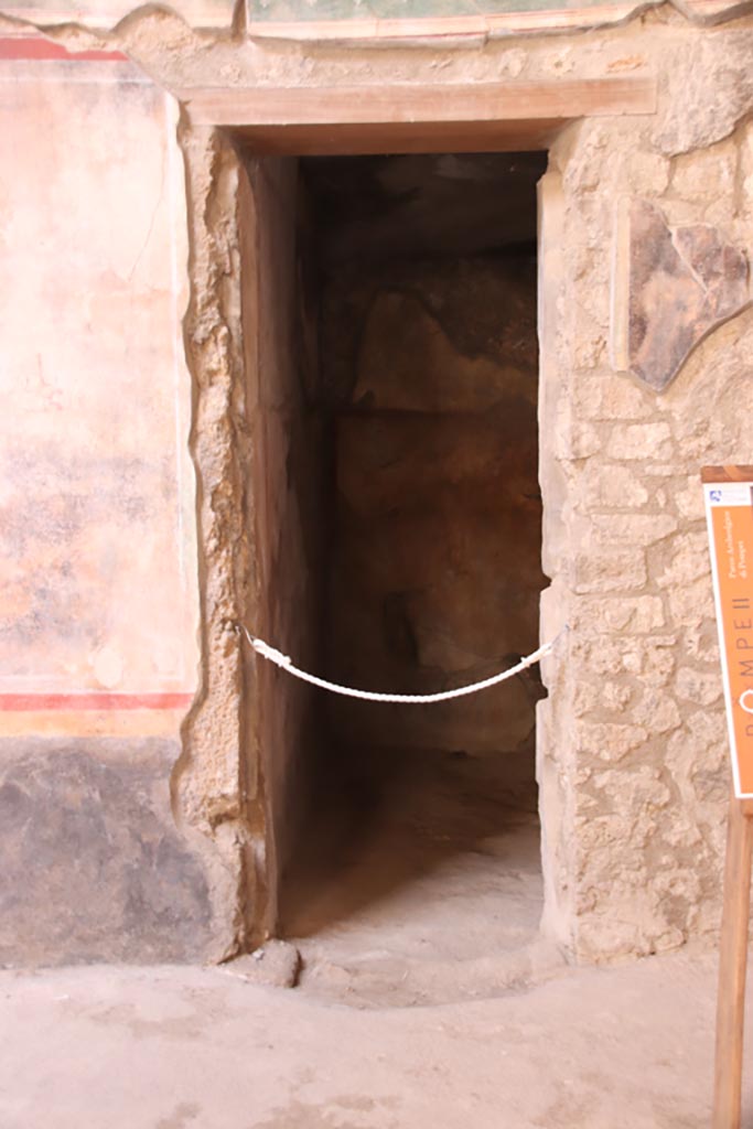 V.2.i Pompeii. October 2023.
Room 1, doorway to room 2a, on west side of atrium. Photo courtesy of Klaus Heese.
