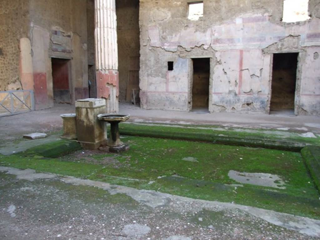V.2.i Pompeii. December 2007.
Room 1, looking south-west across the impluvium to west wall of atrium, on right.
The doorway to corridor 10 is on the left with doorway to room 9 in south wall of ala 8, behind column.