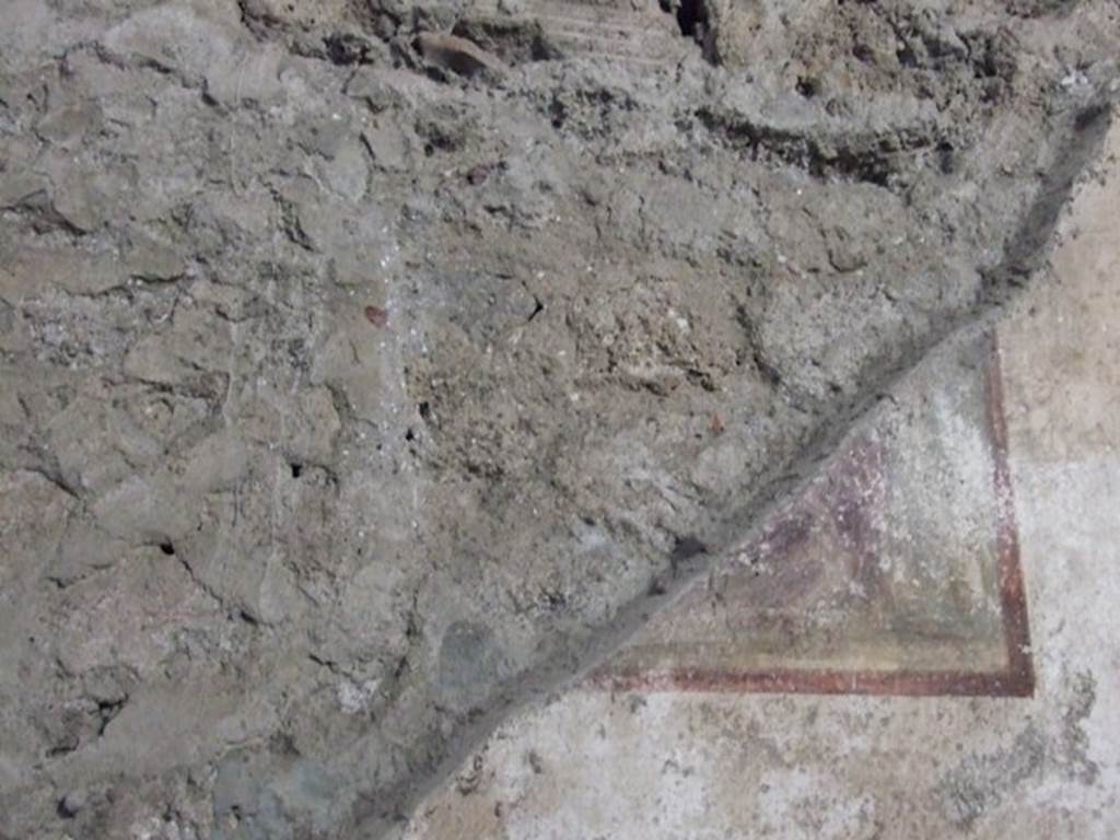 V.2.i Pompeii. December 2007. Room 9, remaining corner of a wall painting on west wall. According to Mau, on the west wall only the lower corner was conserved. He recognised that near to the right margin was the foot of a large chair. To the left of this chair, possibly a sceptre and below, an eagle.
He thought, without doubt, this would have been Giove. See Mau, A., 1893. Mitteilungen des Kaiserlich Deutschen Archaeologischen Instituts, Roemische Abtheilung Volume VIII. (p.46)
Sogliano thought, in NdS, that the remaining fragment of this painting on the west wall would have represented the child Hercules strangling the serpents in the presence of Zeus.
See Notizie degli Scavi, 1896, (p.427)