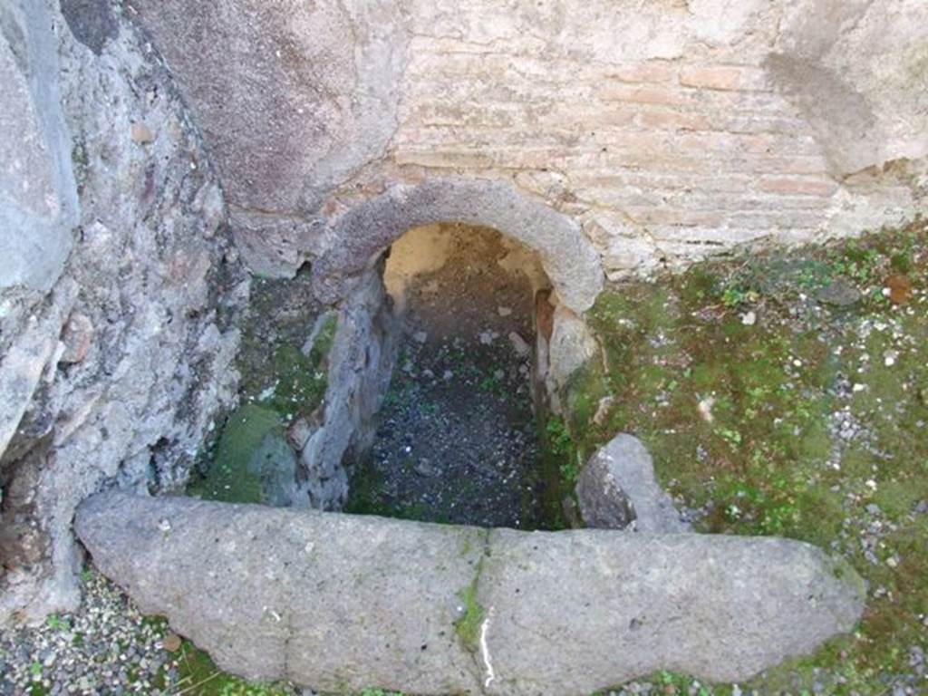 V.2.i Pompeii. December 2007. Room 11, south side of kitchen. Hole in the floor and wall leading into caldarium.