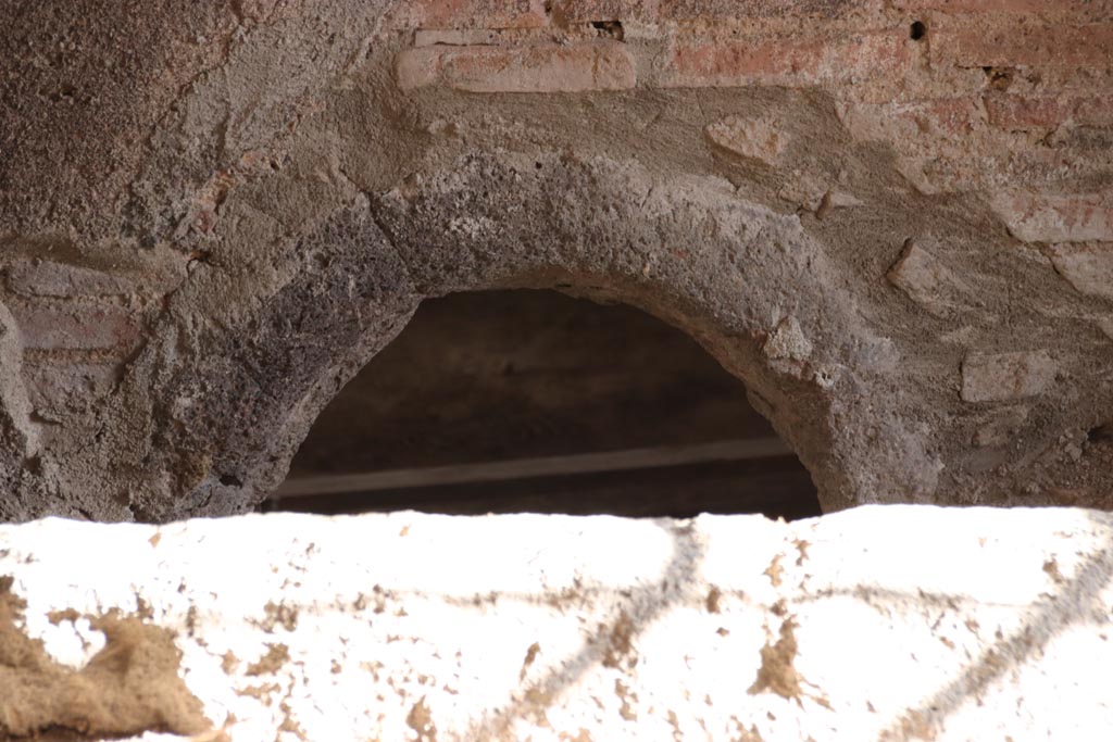 V.2.i Pompeii. October 2023.
Kitchen room 11, wall at south end near the caldarium showing a hole in the floor, used to heat the bath-rooms. Photo courtesy of Klaus Heese.