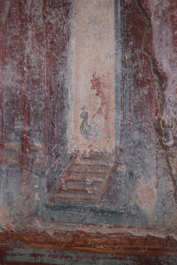 V.6.12 Pompeii. October 2020. Amb. 9.
Detail from architectural decoration (? a peacock) on west side of central painting on south wall of cubiculum.
Photo courtesy of Klaus Heese.
