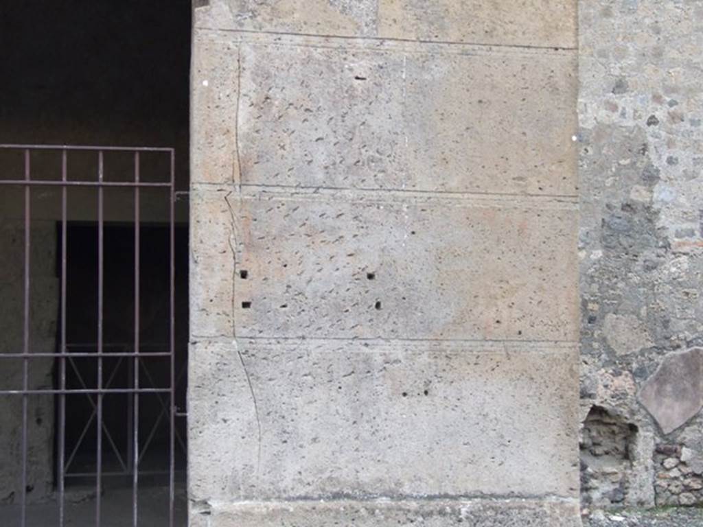 VI.2.2 Pompeii. December 2007. Pilaster on Via Consolare between VI.2.3 and VI.2.2, site of graffiti.
According to Laidlaw �
�In 1841, Lepsius read C. SALLVS[TIVS] on the pier����.
At some time it must have been put under a protective glass cover which eventually fell off, leaving only the four holes for metal cramps that had attached the glass (a common method for protecting inscriptions and paintings on street facades).
The holes, still extant on the left side of the third tufa block above the sidewalk, form a neat rectangle on the pickmarked left side of the pillar, which must have once been plastered.�
See Laidlaw, A., and Stella M. S., 2014. The House of Sallust in Pompeii (VI.2.4): JRA 98. Portsmouth Rhode Island. (p.25). 
