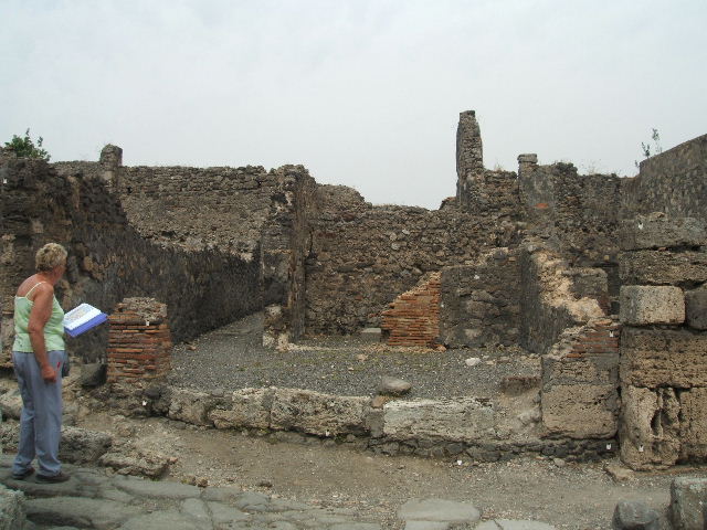 VI.2.7 Pompeii, can be seen on the right. May 2010. Looking east. Model as viewed in Naples Archaeological Museum. According to the model, in the south-east corner of the rear room, as in photo above this one, there used to be steps.