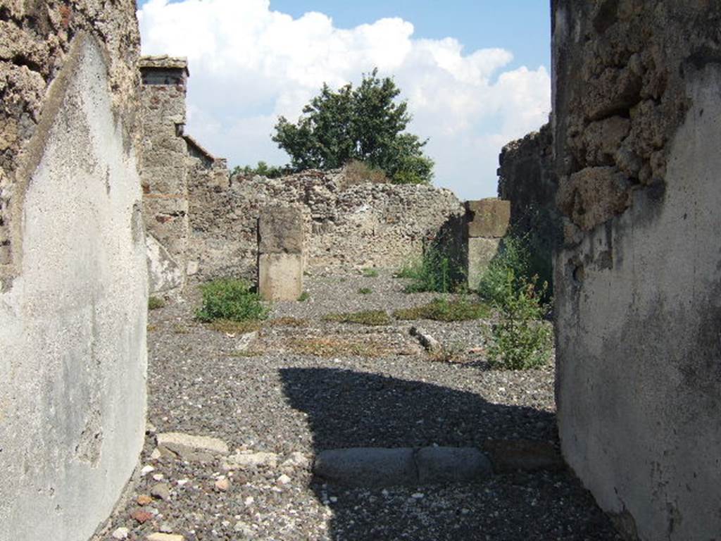 VI.2.12 Pompeii. September 2005. Room 2 atrium, looking east towards room 5, tablinum.
Room 6 is on the left and corridor 4 on the right of the tablinum.