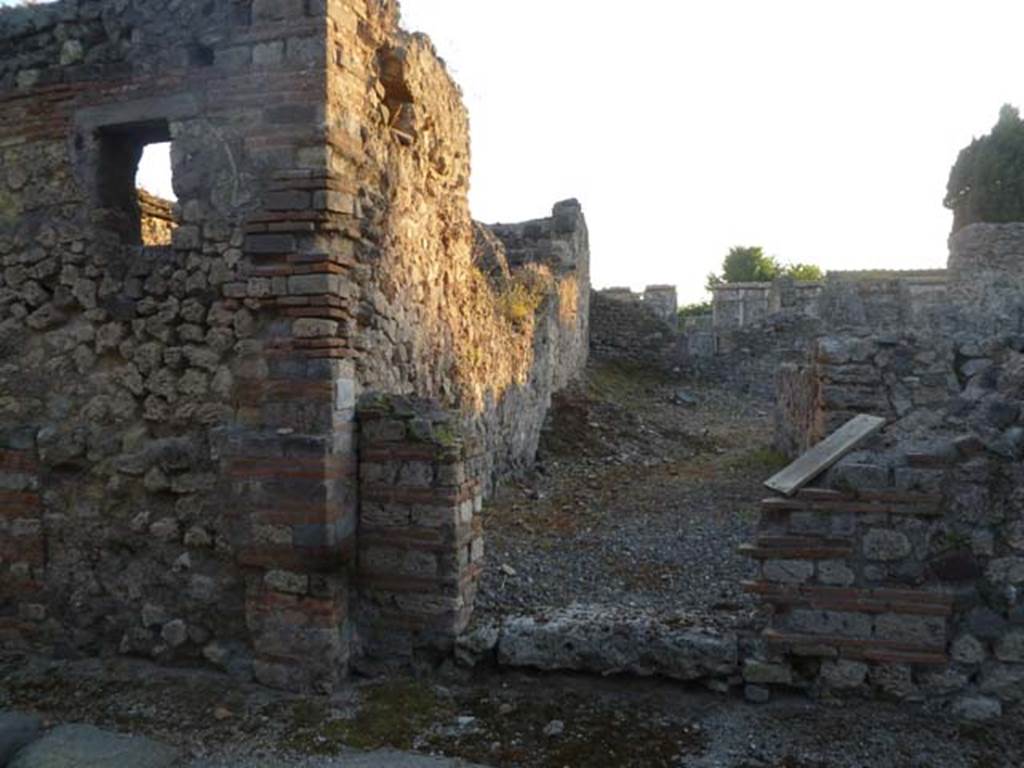 VI.2.20 Pompeii. September 2005. Looking west towards rooms on north side of open area. According to Jashemski, Fiorelli said this site, excavated 1810-11, may have been a hospitium. The entrance from the street led into an open area, which may possibly have had some plantings. A covered passageway on the right of the open area gave access to a large triclinium and two smaller rooms on the north side. See Jashemski, W. F., 1993. The Gardens of Pompeii, Volume II: Appendices. New York: Caratzas. (p.122)

