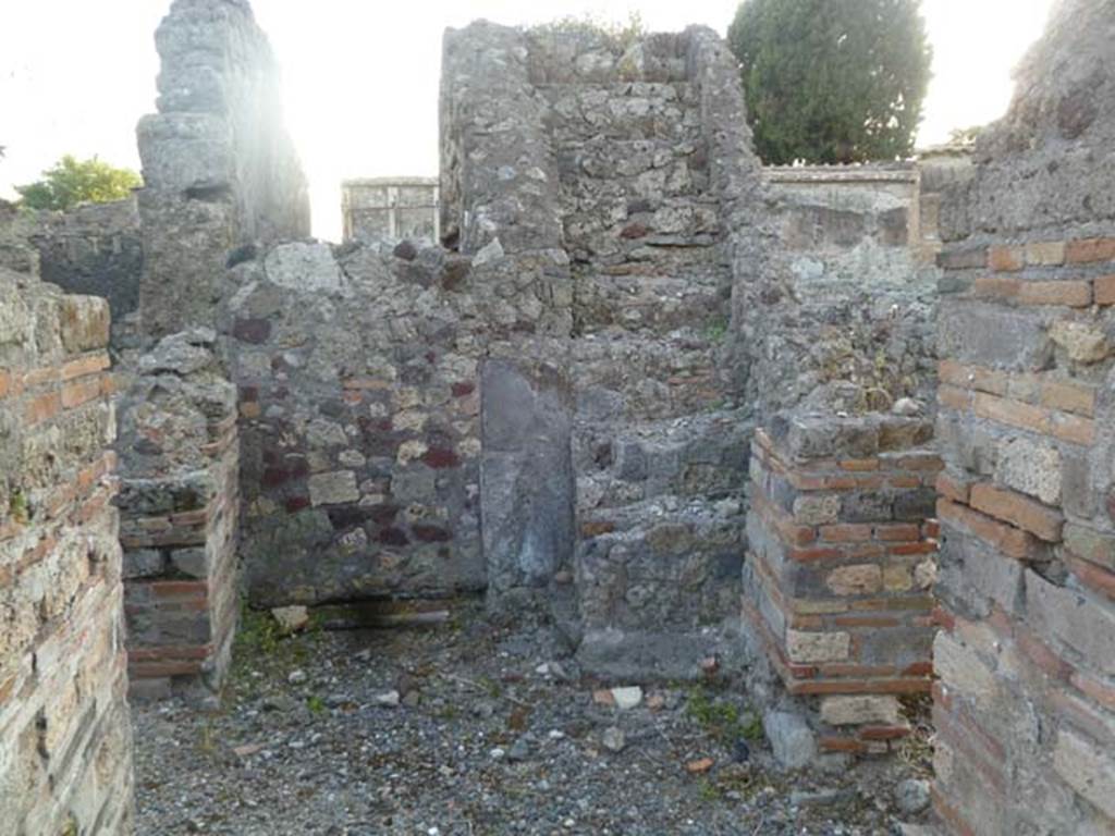 VI.2.20 Pompeii. May 2011. Looking west towards stone staircase.
On the left and the right would be the doorways into the two rooms described by Fiorelli as being used for either dormitories or dining areas.
Ahead is the bricked-up wall at the end of the fauces which would have led towards the atrium of VI.2.17, and the stone steps to the upper floor.