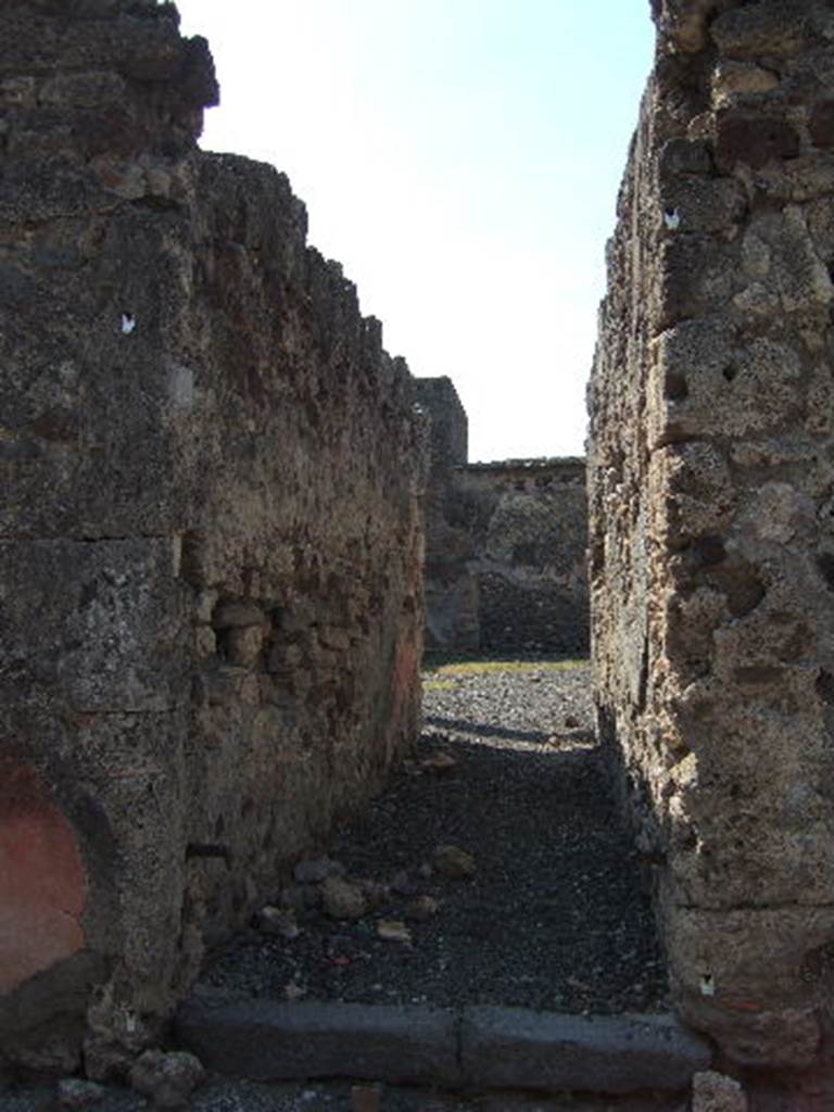 VI.2.25 Pompeii. September 2005. Looking west along long narrow entrance corridor leading directly into the peristyle garden.