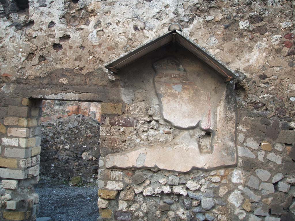 VI.4.4 Pompeii. December 2004. North wall, with remains of painted lararium shrine.